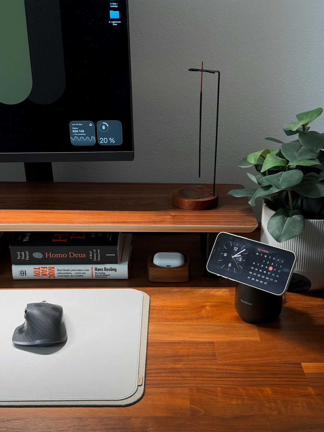 Modern wooden desk with computer monitor and organized office accessories.