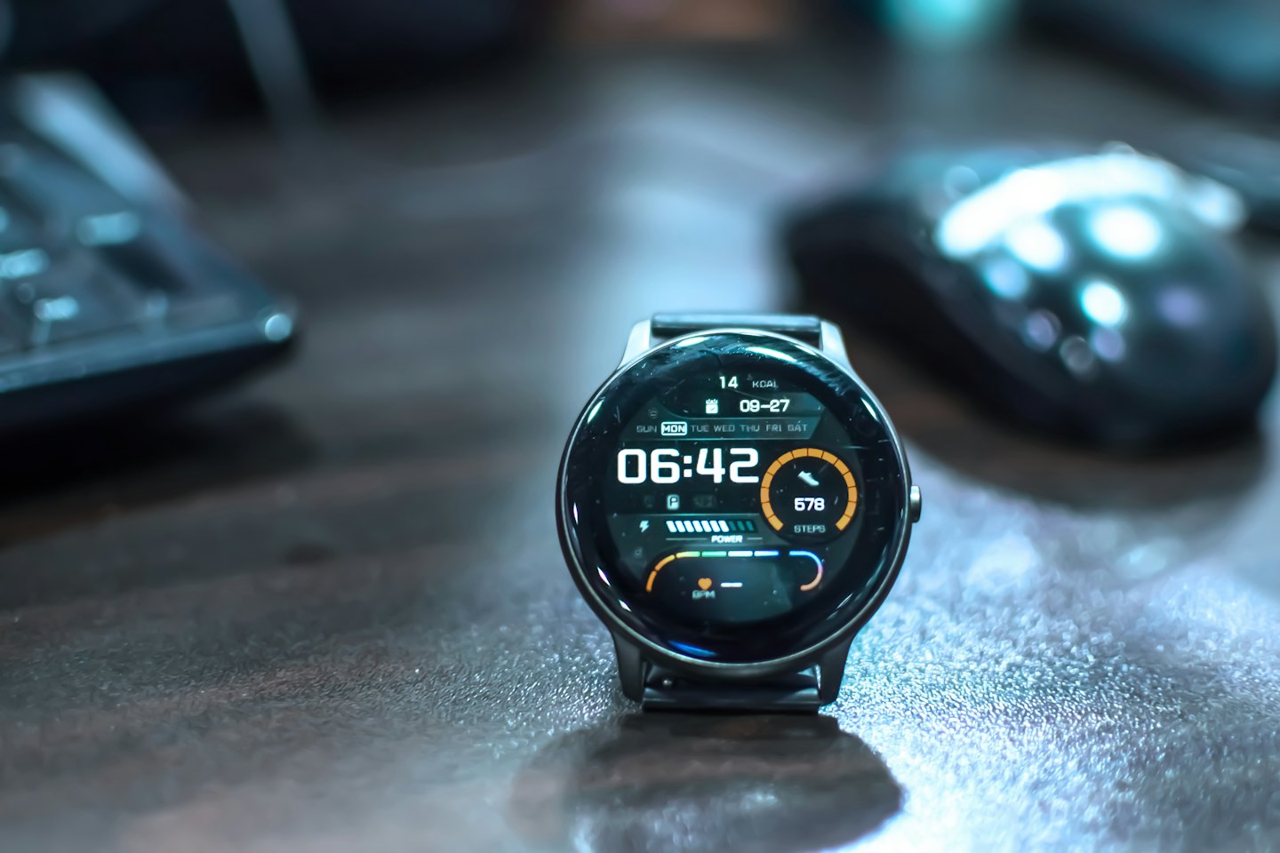 Smartwatch on a dark desk displaying health data.